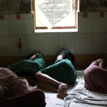 Women lying on the ground in a room.
