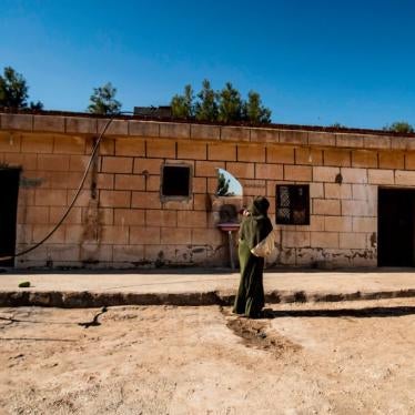 A 22-year-old Iraqi Yezidi woman carries her 2-year-old son at her home in al-Hasakeh, northeastern Syria, on November 23, 2020.