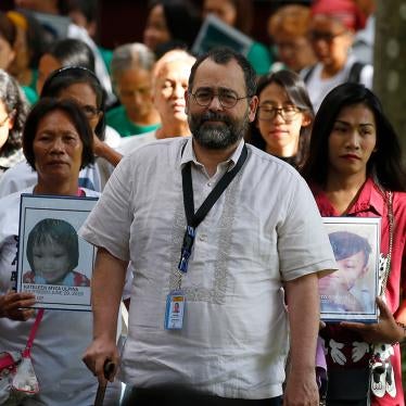 Commission on Human Rights Chair Chito Gascon, center, leads families of victims of alleged extrajudicial killings in the "war on drugs" in a march calling for an investigation by the UN Human Rights Council in Manila, Philippines, July 9, 2019.