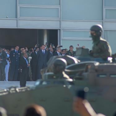 Brazil’s President Jair Bolsonaro watches a military parade in front of the presidential palace in Brasilia on August 10, 2021.