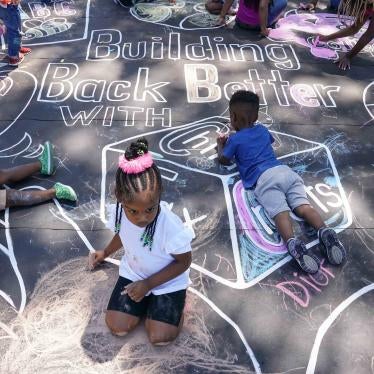 Children and teachers complete a mural in celebration of the launch of the Child Tax Credit on July 14, 2021 at the KU Kids Deanwood Childcare Center in Washington, DC.