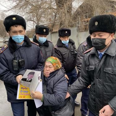 Police detain Khalida Akytkhan outside the Chinese Consulate in Almaty, Kazakhstan, where relatives of people detained or disappeared in Xinjiang, China have been protesting for over 300 days.