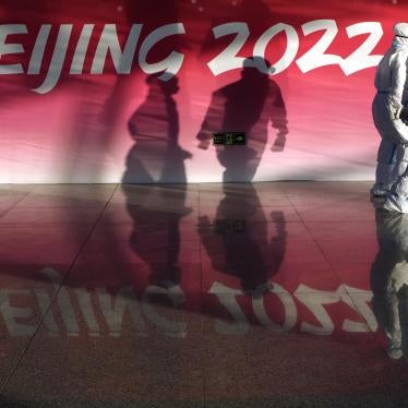 Olympic workers in protective gear walk through the Beijing Capital International Airport to assist passengers ahead of the 2022 Winter Olympics, in Beijing, January 31, 2022. 
