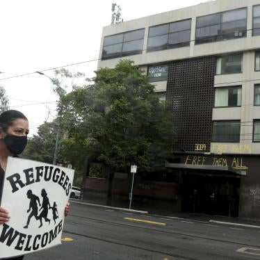 A protester outside the Park Hotel calling for the release of refugees being detained inside the hotel in Melbourne