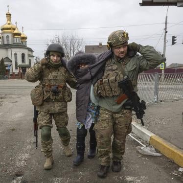 Ukrainian soldiers help a woman in the town of Irpin, Ukraine on March 6.