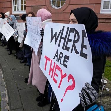 Women hold banners with phrases on them. One reads, "Where are they?"