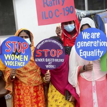 A group of women hold protest signs