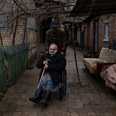 An older woman using a wheelchair is evacuated from a hospice