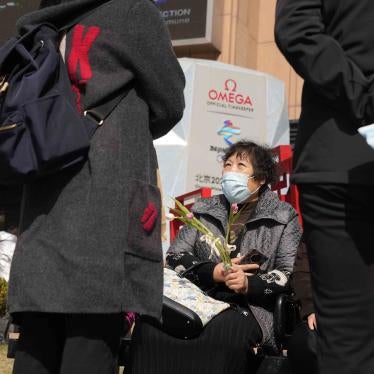 A woman holds flowers on International Women's Day on March 8, 2022, in Beijing.