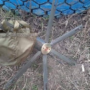 A POM-3 antipersonnel mine and its parachute that failed to deploy correctly and was found by deminers in the Kharkiv region, Ukraine, March 2022. 
