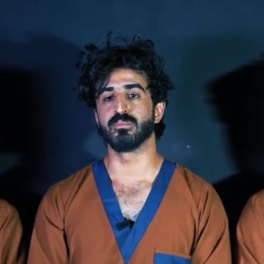 Ajmal Haqiqi (center) and two colleagues after their arrest