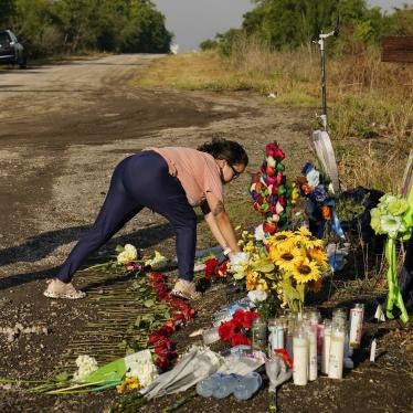 Mourners lay flowers at a makeshift memorial