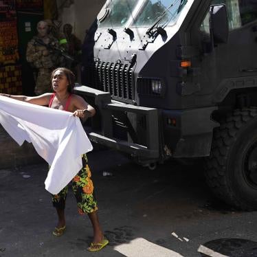 A resident waves a white sheet in protest and to ask for peace after a police operation that resulted in multiple deaths, in the Complexo do Alemao favela in Rio de Janeiro, Brazil, July 21, 2022. 