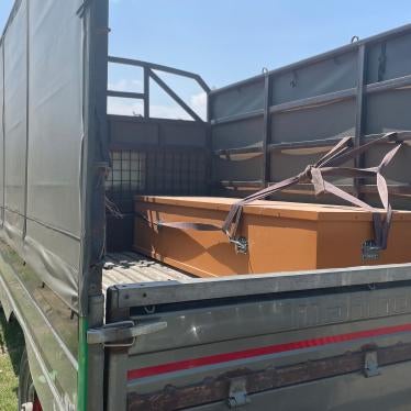A casket lies on the back of a truck