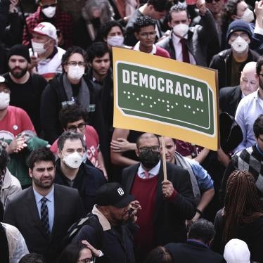 A protester holds a sign reading “Democracy” in Portuguese and in Braille at a rally in in São Paulo, August 11, 2022.
