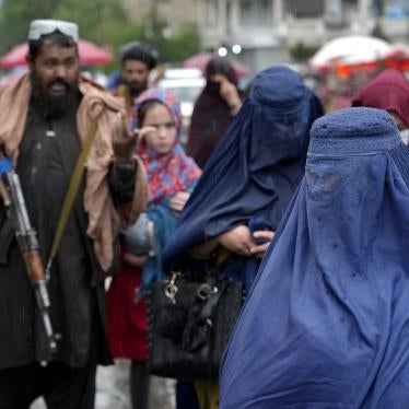 Afghan women walking by Taliban security forces in Kabul