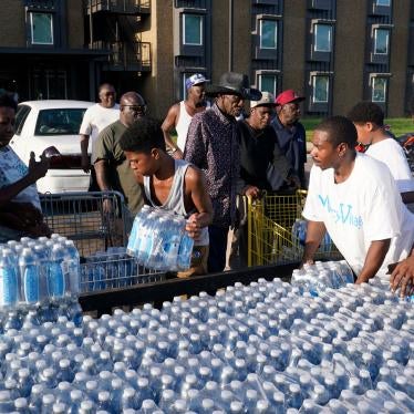 People are given cases of bottled water