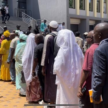 Victims and their families of crimes committed during Guinea’s 2009 stadium massacre line up to enter a courthouse in Conakry, Guinea.