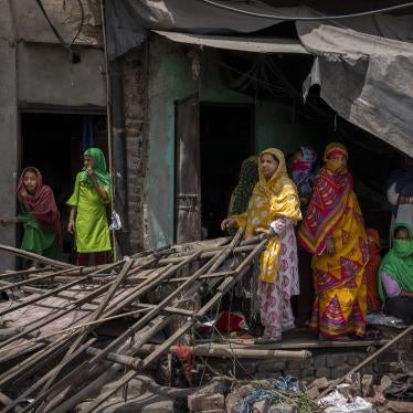 omen stand near the rubble of a shop after authorities demolished a number of Muslim-owned businesses in New Delhi. 