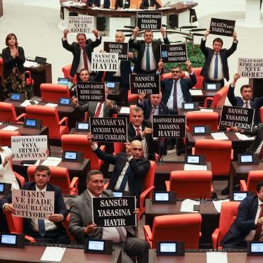Opposition Republican People's Party deputies hold signs in protest of a government-backed bill that criminalizes "disinformation," at the Grand National Assembly of Turkey in Ankara, October 4, 2022.