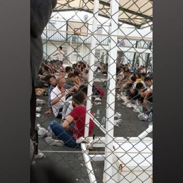 Migrants and refugees held in a basketball court for hours while waiting for a cell