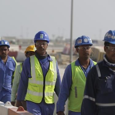 Workers walk to the Lusail Stadium, one of the 2022 World Cup stadiums, in Lusail, Qatar.