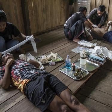 Volunteer medics helping men injured by landmines in Myanmar. 
