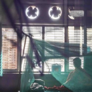 A patient sits on her bed after being admitted with dengue at Sukraraj Tropical and Infectious Disease Hospital in Kathmandu.