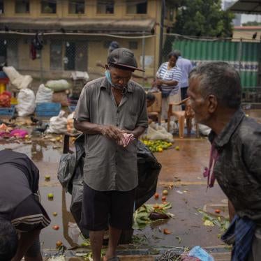 A man counts money at a marketplace in Colombo, Sri Lanka
