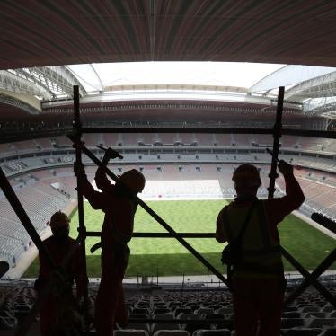 Laborers remove scaffolding at the Al Bayt stadium in Al Khor, Qatar, Monday, April 29, 2019.
