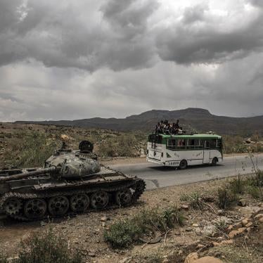 A bus carrying civilians passes a destroyed tank outside Mekelle, the capital of Ethiopia's Tigray region.