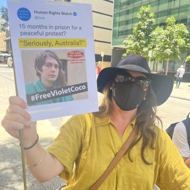  A protester in Perth, Australia, carries a sign with a Human Rights Watch tweet on it using our Daily Brief headline, "Seriously, Australia?", about the 15-month sentence of Violet Coco for peaceful protest. December 5, 2022. (c) Sophie McNeill, Human Rights Watch 2022