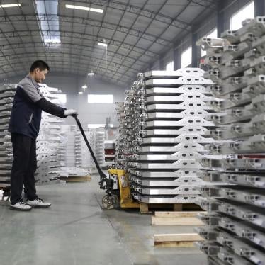 A worker moves aluminum auto parts in central China's Anhui province.