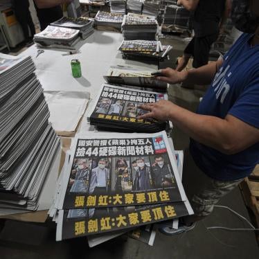 Workers pile Apple Daily newspapers at the printing factory in Hong Kong.