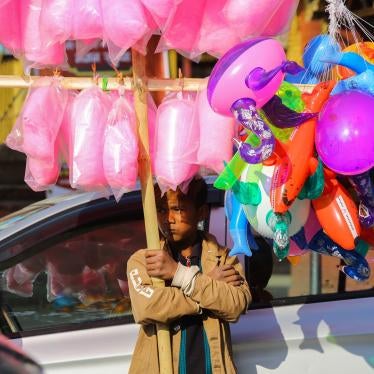 A child awaits customers to sell cotton candy and balloons in Kathmandu, Nepal.
