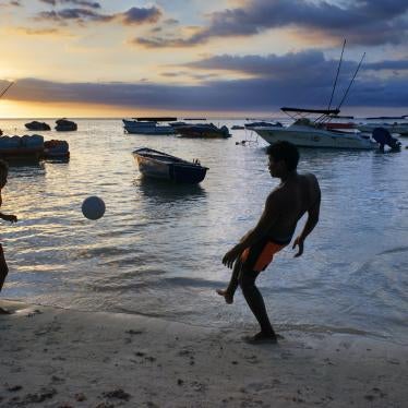 Children playing at sunset at Trou aux Biches in Mauritius. 