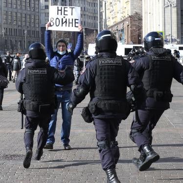 Police officers detain a man holding a poster that reads "no war" during an unsanctioned protest on March,13,2022 at Manezhnaya Square in front of the Kremlin, in Moscow, Russia. 