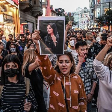 A protester in Istanbul, Turkey, holds a portrait of Mahsa (Jina) Amini during a demonstration on September 20, 2022.