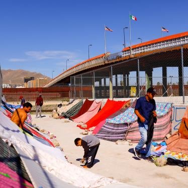 Venezuelan migrants stand near the Paso del Norte International Bridge, in Ciudad Juarez, Mexico.