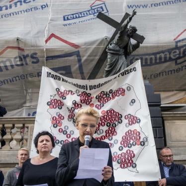 Joanna Scheuring-Wielgus, a social activist and politician, reads testimony from a child who was molested by a priest during a protest in Warsaw, October 7, 2018.