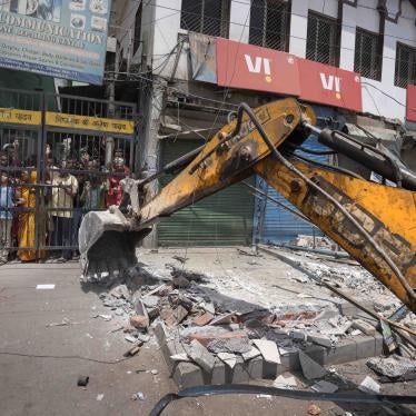 A bulldozer razes structures in an area affected by communal violence during a Hindu religious procession in New Delhi's Jahangirpuri neighborhood, April 20, 2022.
