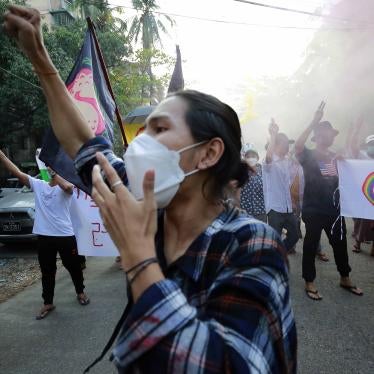 Demonstrators make the defiant three-finger salute and hold flares during a protest against the military coup in Yangon, Myanmar.