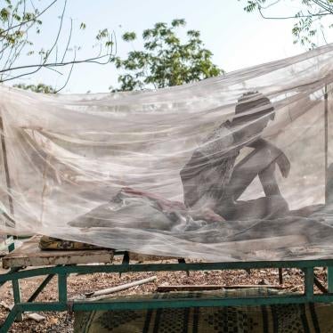 A civilian man who fled violence sits in a bed covered with a mosquito net at the compound of the Agda Hotel, in the city of Semera, Ethiopia, February 17, 2022.
