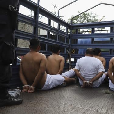 People arrested by police wait in zip tie handcuffs in the back of a truck to be transferred to a prison at the Police Delegation of San Bartolo in Soyapango, El Salvador, Tuesday, Aug. 16, 2022.