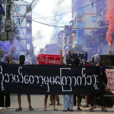 Protesters hold a banner reading “We will never be frightened,” in Yangon, Myanmar