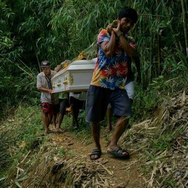 Family and members of the Indigenous Dumagat tribe carry the coffins of Puroy and Randy Dela Cruz to be buried in Rizal province