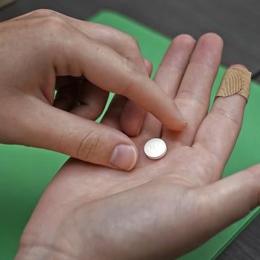 A patient in a Kansas clinic prepares to take the first of two pills for a medical abortion.