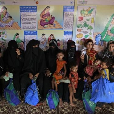 Rohingya refugees wait at a UN World Food Program facility to receive food supplements for their children in Kutupalong refugee camp.