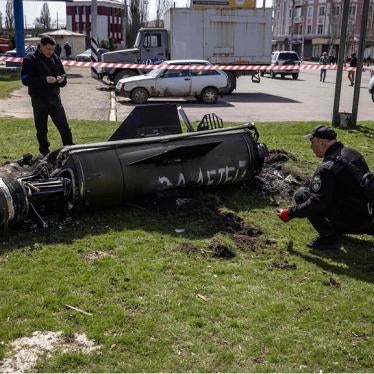 Ukrainian authorities inspect the rocket motor and guidance section of a Tochka-U missile next to the main building of the Kramatorsk train station in eastern Ukraine on April 8, 2022. The phrase “Payback for the children” is painted in Russian on the missile. 