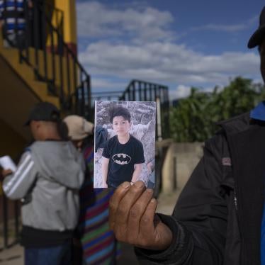 A man shows a portrait of Wilmer Tulul in Tzucubal, Guatemala. Wilmer and his cousin Pascual, both 13, were among the dead discovered inside a tractor-trailer near auto salvage yards on the edge of San Antonio, Texas.